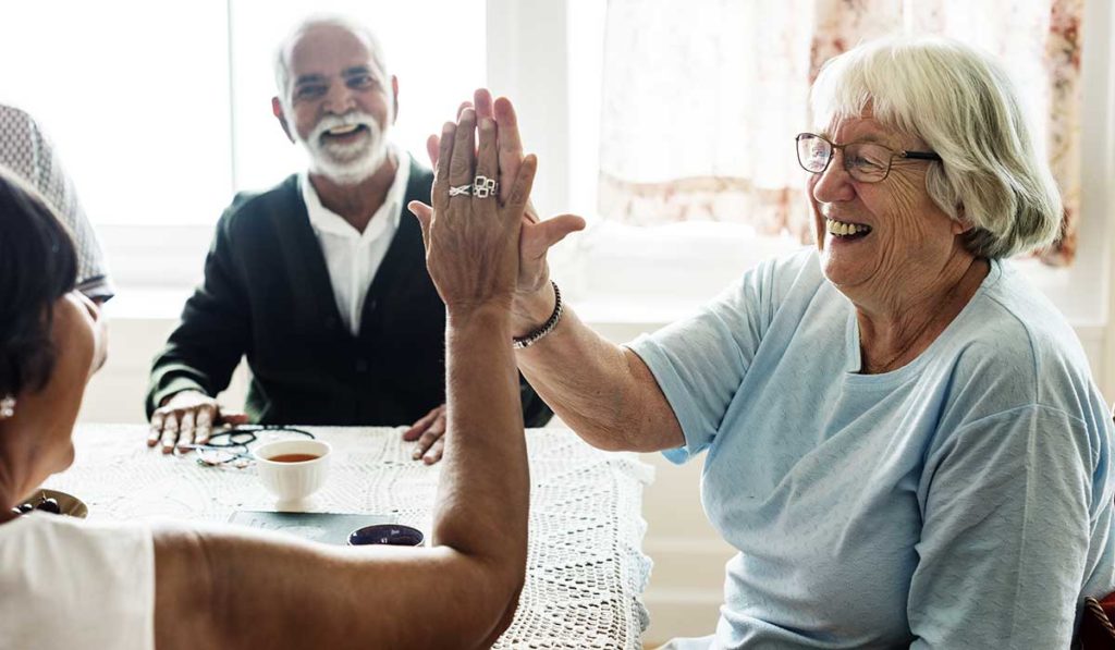 Senior women with Parkinson's giving a high five