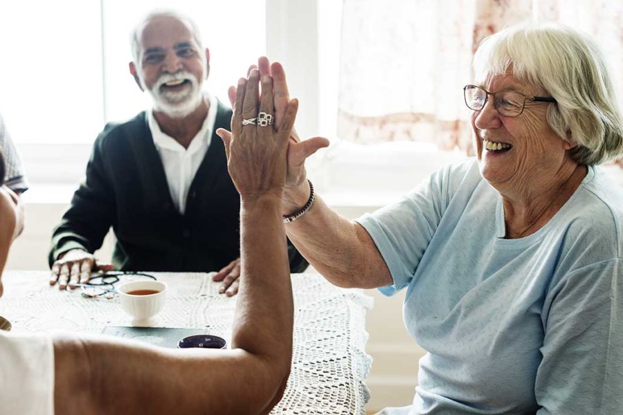 Senior women with Parkinson's giving a high five